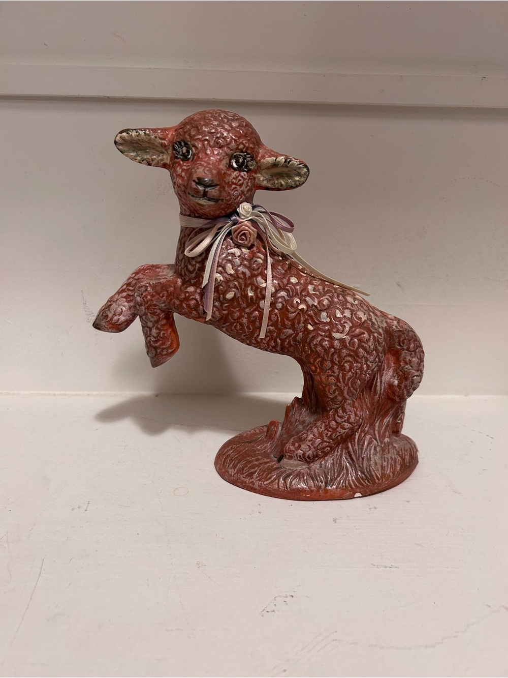 Cute red lamb statue with floral collar. Call outs!